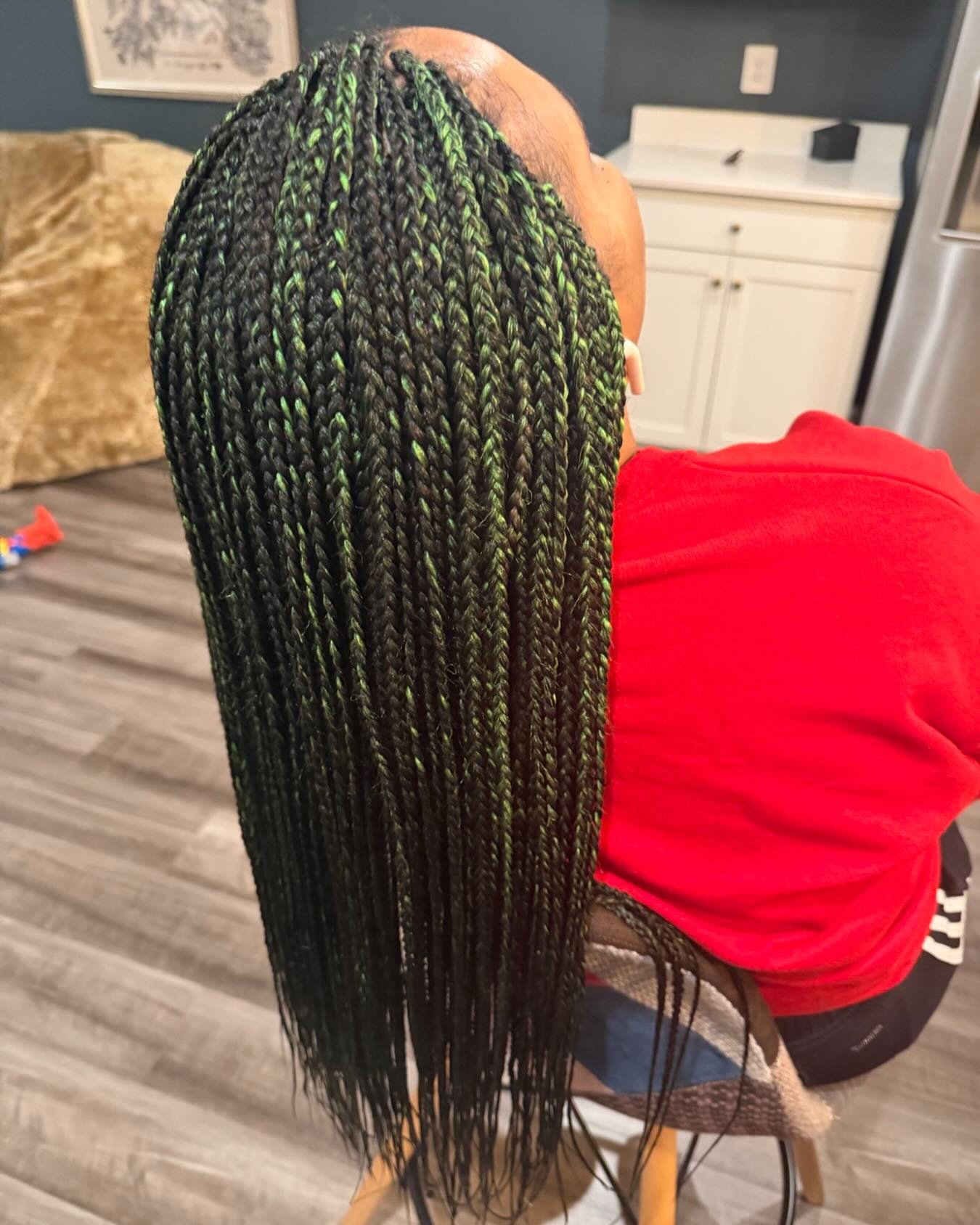 Knotless braids with green highlights by Braids On Wheels DMV